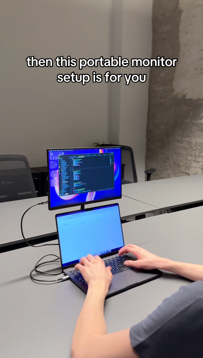 Monitor with stand on coworking desk setup